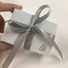 white gift box with silver bow